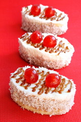 Cakes with biscuit, butter cream and coconut