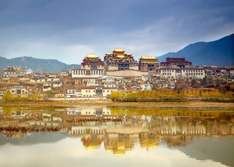 Landscape with tibetan monastery and lake
