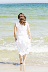 Fototapeta na wymiar Summer happy woman on the beach