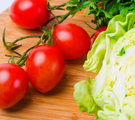 tomatoe, parsley, cabbage on wood desk