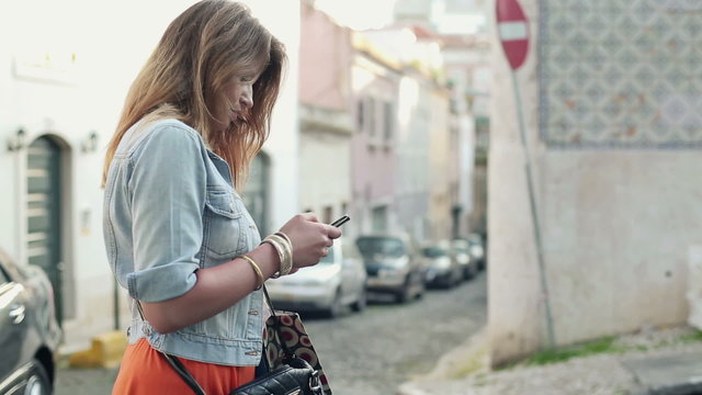 Woman taking photo with cellphone in the city, steadicam shot