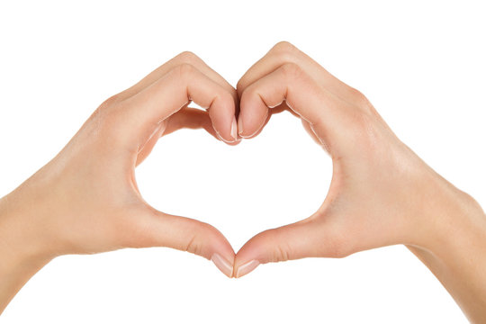 Close up of female hands making heart shape