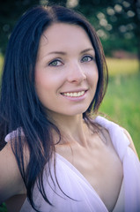 A portrait of a young pretty girl in a white dress