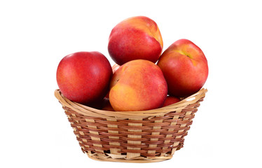 Naklejka na ściany i meble Fresh fruit nectarines in the basket, on white background