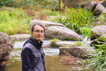Man Enjoying autumn forest with river