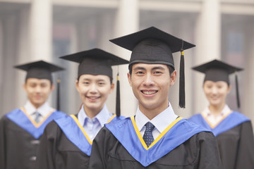  Four University Graduates Smiling, Looking at Camera