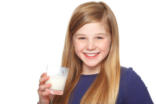 girl with a glass of milk and milk moustache smiling