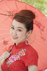Young Woman in Qipao with Umbrella