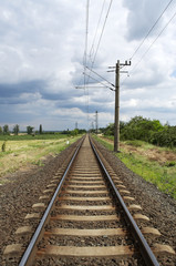 Fototapeta na wymiar Straight railway leads to the horizon