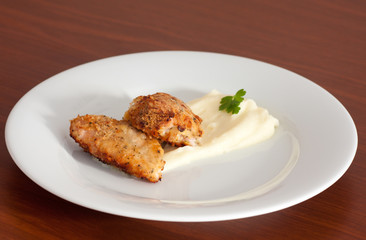 chicken covered with cracker crumbs with potato mash