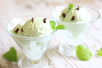 Pistachio mint ice cream closeup on white planks in restaurant