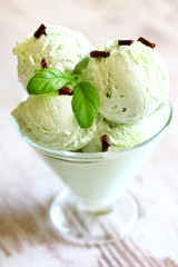 Pistachio mint ice cream closeup on white planks in restaurant