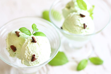 Pistachio mint ice cream closeup on white planks in restaurant