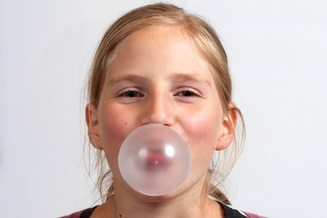 Girl blowing a  bubble gum bubble