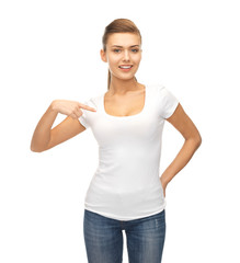 smiling woman pointing at blank white t-shirt