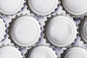 Metal beer bottle tops on white background