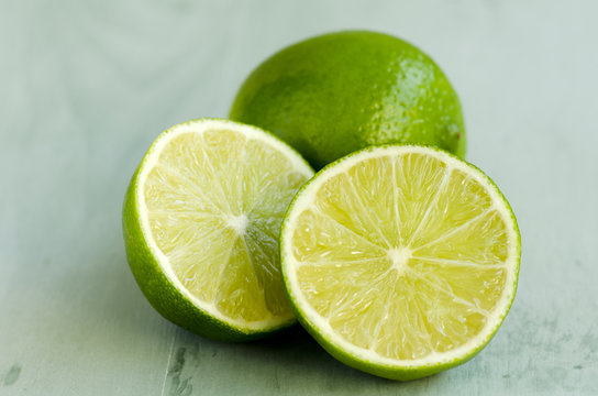 Limes in a green wooden background