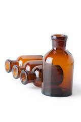 Small chemical glass bottles on white background