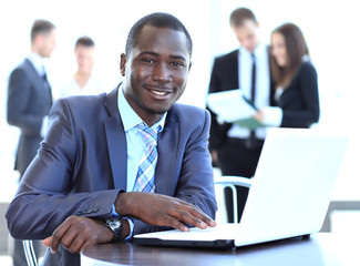 Portrait of a handsome young business man with a laptop