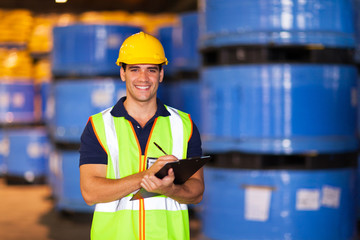 young worker in warehouse recording stock