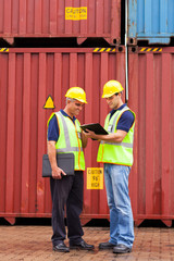 inspectors standing next to containers