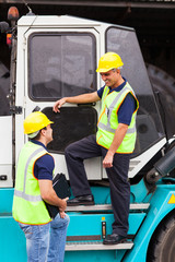 forklift driver talking to co-worker