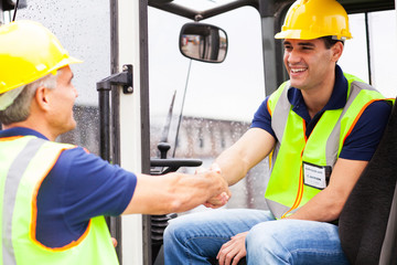 warehouse forklift drivers handshaking © michaeljung