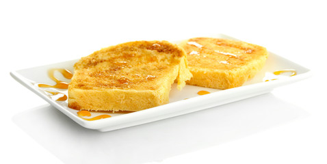 White bread toast with honey on plate, isolated on white