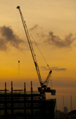 crane of building construction on dusky sky