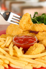 Fried chicken nuggets with french fries and sauce