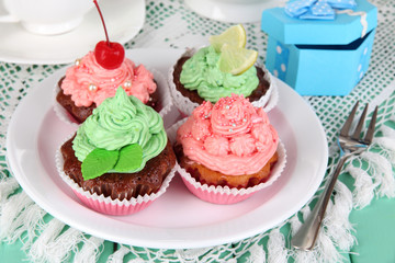 Delicious beautiful  cupcakes on dining table close-up