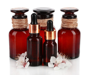 Aroma oils with flowers isolated on white