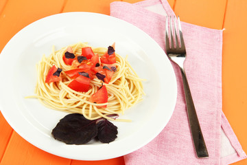 Spaghetti with tomatoes and basil leaves