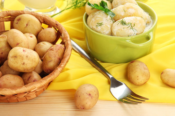 Tender young potatoes with sour cream and herbs in pan