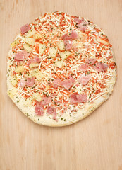Frozen pizza on a wooden board