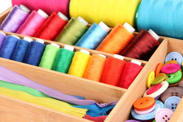 Colorful threads for needlework in wooden box close up