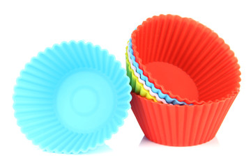 Stack of colorful cupcake cases isolated on white