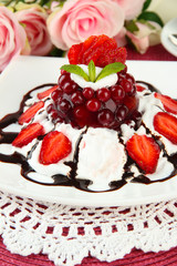 Tasty jelly dessert with fresh berries, on pink roses