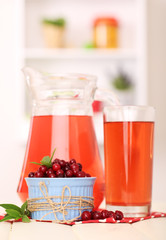 Pitcher and glass of cranberry juice with red cranberries