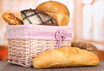 Baked bread in wicker basket on window background