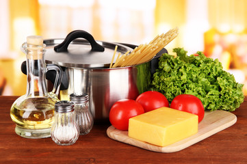 Ingredients for cooking pasta on table in kitchen