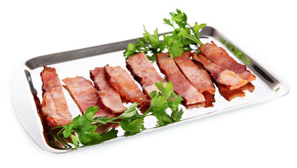 Fried bacon on metal tray isolated on white