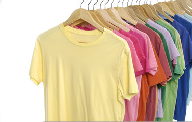 different colors shirt on wooden hangers