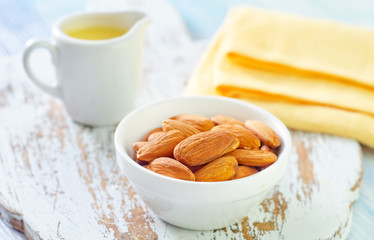 almond essential oil and almond in bowl