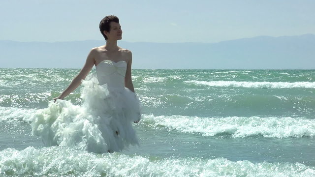 Bride and waves. Slow Motion at a rate of 240 fps