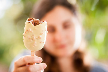 White and brown chocolate ice-cream held by girl