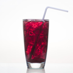 Grape juice with ice in glass isolated