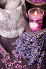 Obraz na płótnie Canvas Burning candles, a bouquet of dried lavender and sea salt
