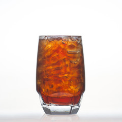 Root beer flavor aerated drinks with soda in glass isolated