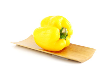 The yellow of Sweet pepper in the Bamboo dish.